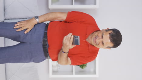 Vertical-video-of-The-old-man-texting-on-the-phone-laughs.